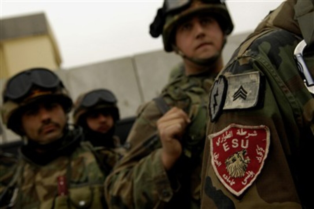 Iraqi policemen wait to conduct an Iraqi police led mission searching villages by the Emergency Services Unit, April 1, 2007. The Iraqi police were assisted by Alpha Company, 2nd Battalion, 25th Infantry Division, Schofield Barracks, Hawaii.