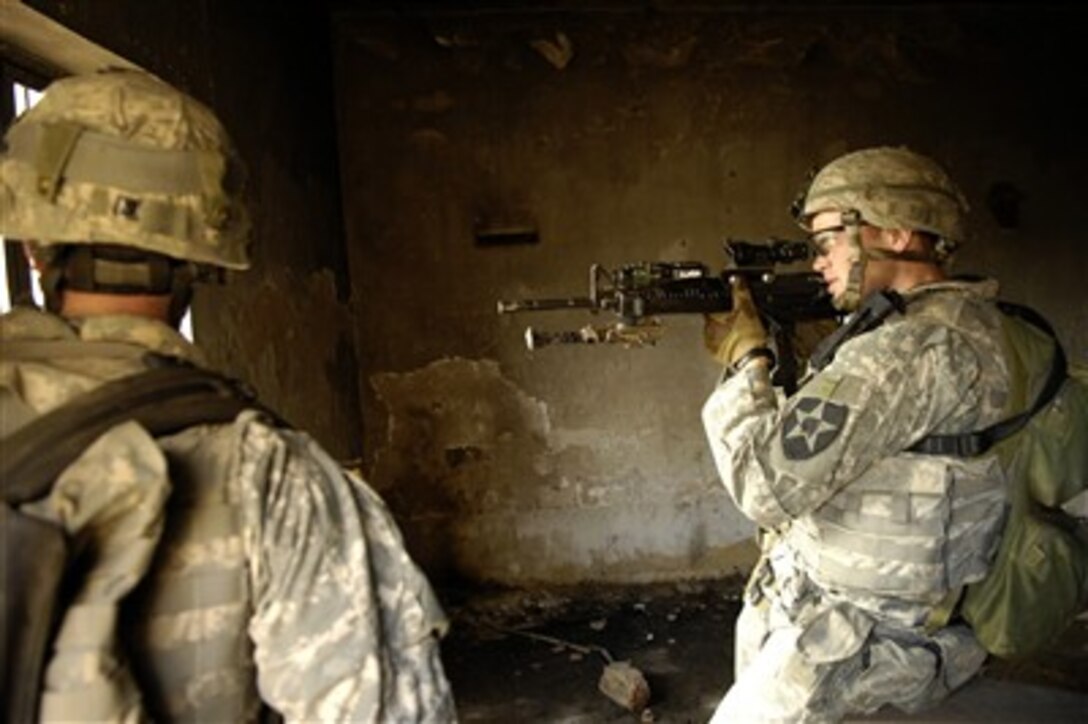 U.S. Army Spc. Kyle Laney watches for the enemy during a cordon and search for weapons caches and insurgents in Old Baqubah, Iraq, on April 2, 2007.  Laney is from the 5th Battalion, 20th Infantry Regiment, 3rd Stryker Brigade Combat Team, 2nd Infantry Division.  