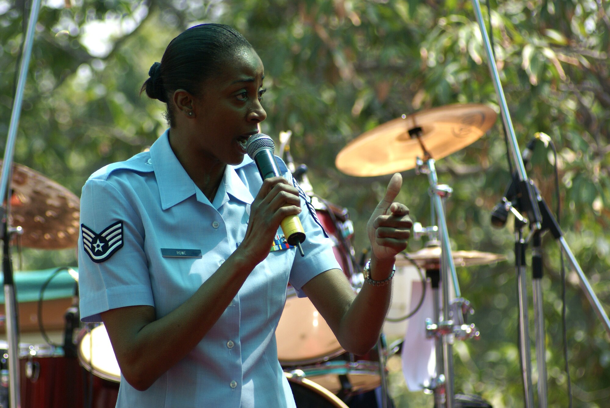 Staff Sgt. Felita Rowe, Pacific Air Forces Band of the Pacific Asia, Pacific Trends vocalist, performs "Life is a Highway" during the Indian Air Force Platinum Jubilee Tattoo. (Photo by Marine Cpl. Ashleigh Bryant VIRIN 070326-M-0040B-350)
      