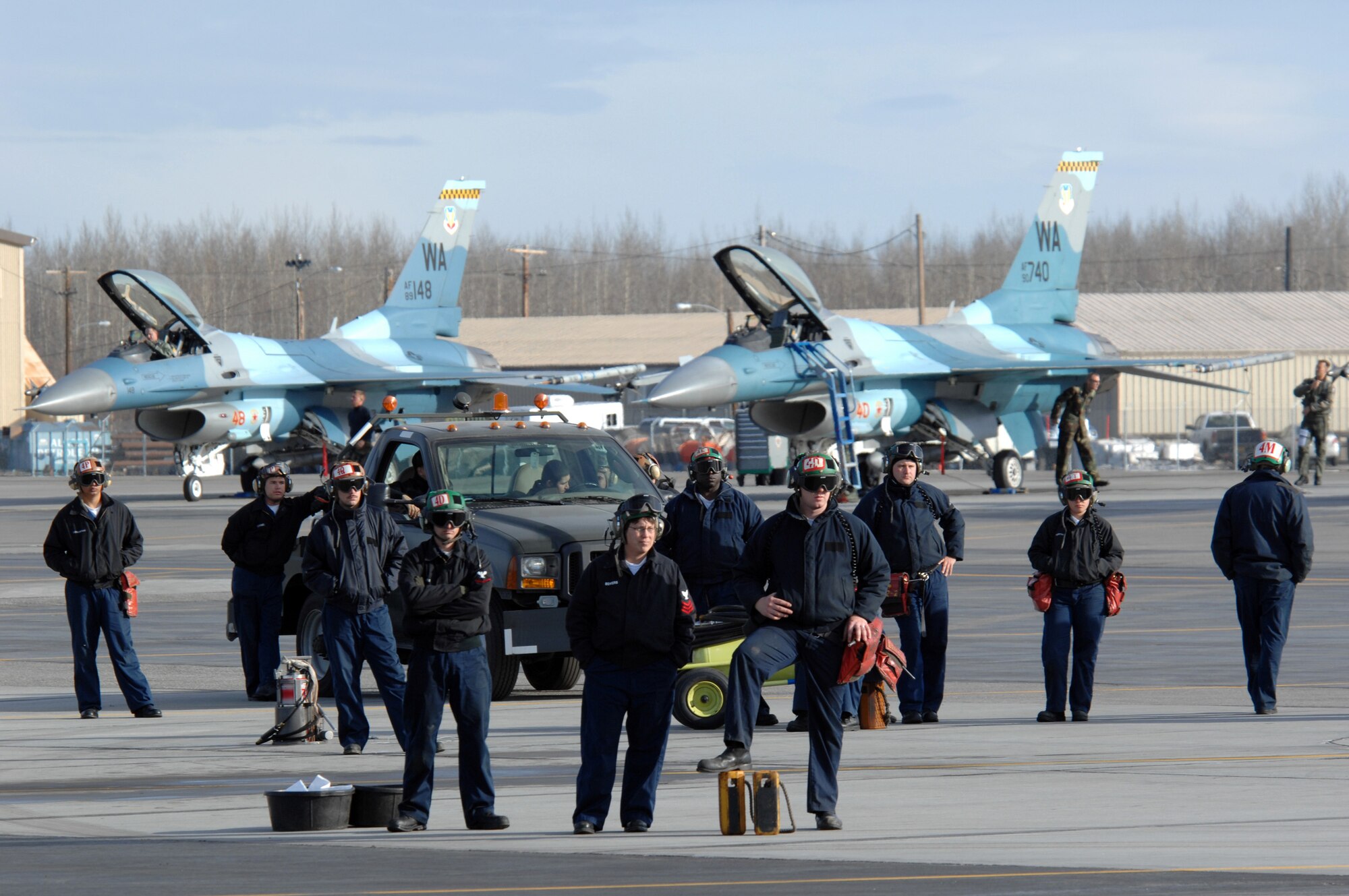 EIELSON AIR FORCE BASE, Alaska -- Navy crew members from Strike Fighter Squadron Eight Seven (VFA-87) watch as their F/A-18 aircraft take off for a mission during Red Flag-Alaska 07-1 here on April 10. Red Flag-Alaska is a Pacific Air Forces-directed field training exercise for U.S. forces flown under simulated air combat conditions. It is conducted on the Pacific Alaskan Range Complex with air operations flown out of Eielson and Elmendorf Air Force Bases. 
(U.S. Air Force Photo by Staff Sgt Joshua Strang) 
