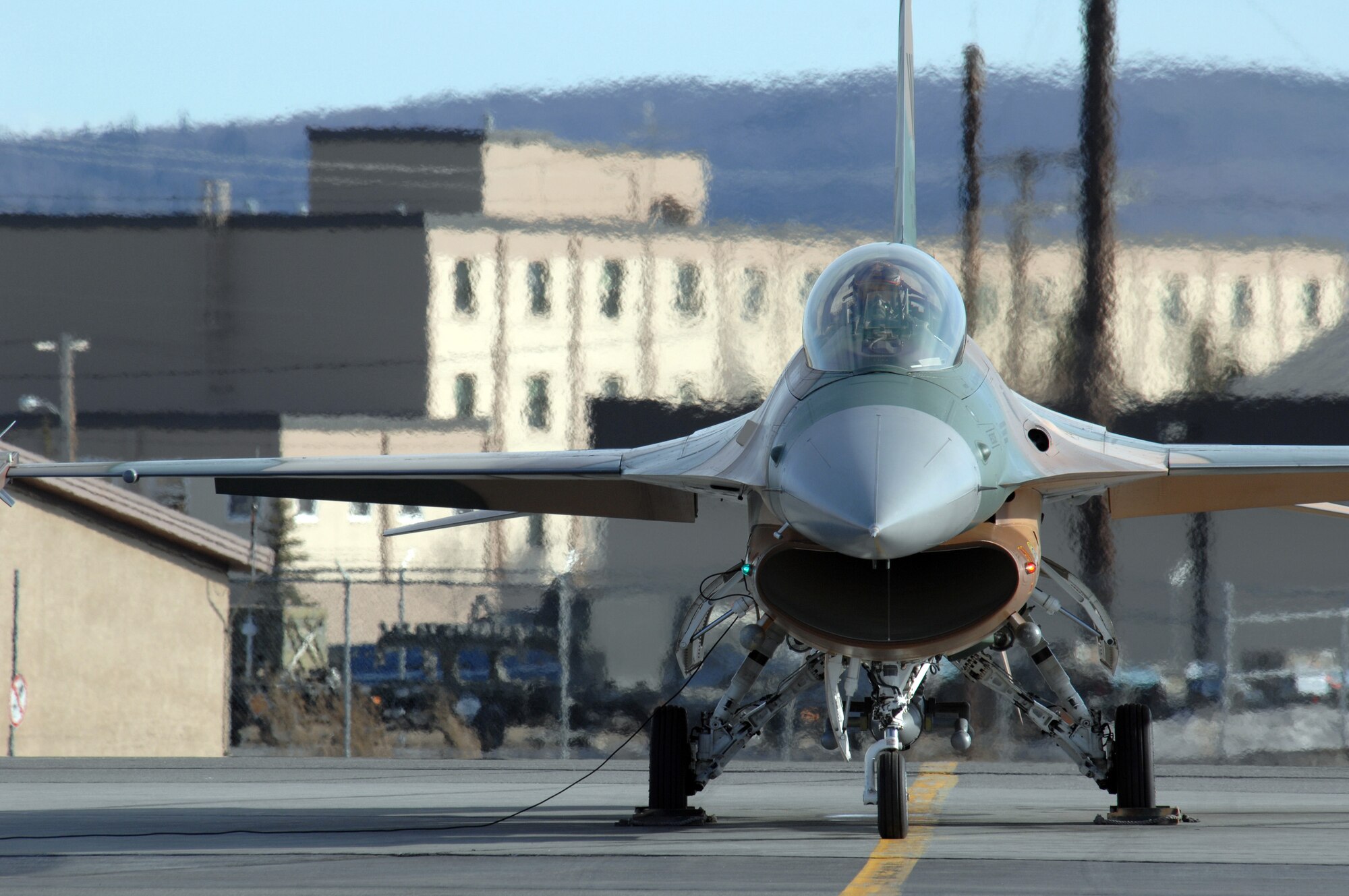 EIELSON AIR FORCE BASE, Alaska -- An F-16 Fighting Falcon from the 64th Aggressor Squadron, Nellis Air Force Base, Nevada prepares to take off for a mission during Red Flag-Alaska 07-1 here on April 10. Red Flag-Alaska is a Pacific Air Forces-directed field training exercise for U.S. forces flown under simulated air combat conditions. It is conducted on the Pacific Alaskan Range Complex with air operations flown out of Eielson and Elmendorf Air Force Bases. 
(U.S. Air Force Photo by Staff Sgt Joshua Strang) 