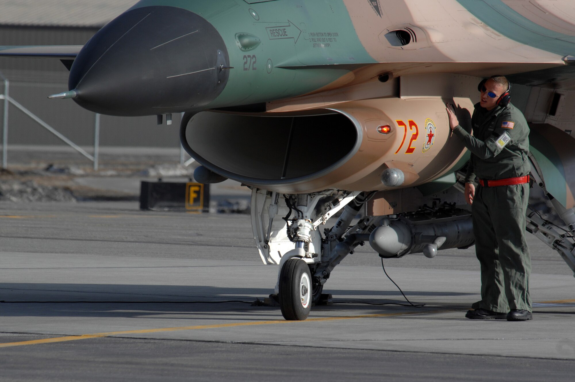 EIELSON AIR FORCE BASE, Alaska -- A Maintainer from the 64th Aggressor Squadron, Nellis Air Force Base, Nevada, preps an F-16 prior to a mission during Red Flag-Alaska 07-1 here on April 10. Red Flag-Alaska is a Pacific Air Forces-directed field training exercise for U.S. forces flown under simulated air combat conditions. It is conducted on the Pacific Alaskan Range Complex with air operations flown out of Eielson and Elmendorf Air Force Bases. 
(U.S. Air Force Photo by Staff Sgt Joshua Strang) 