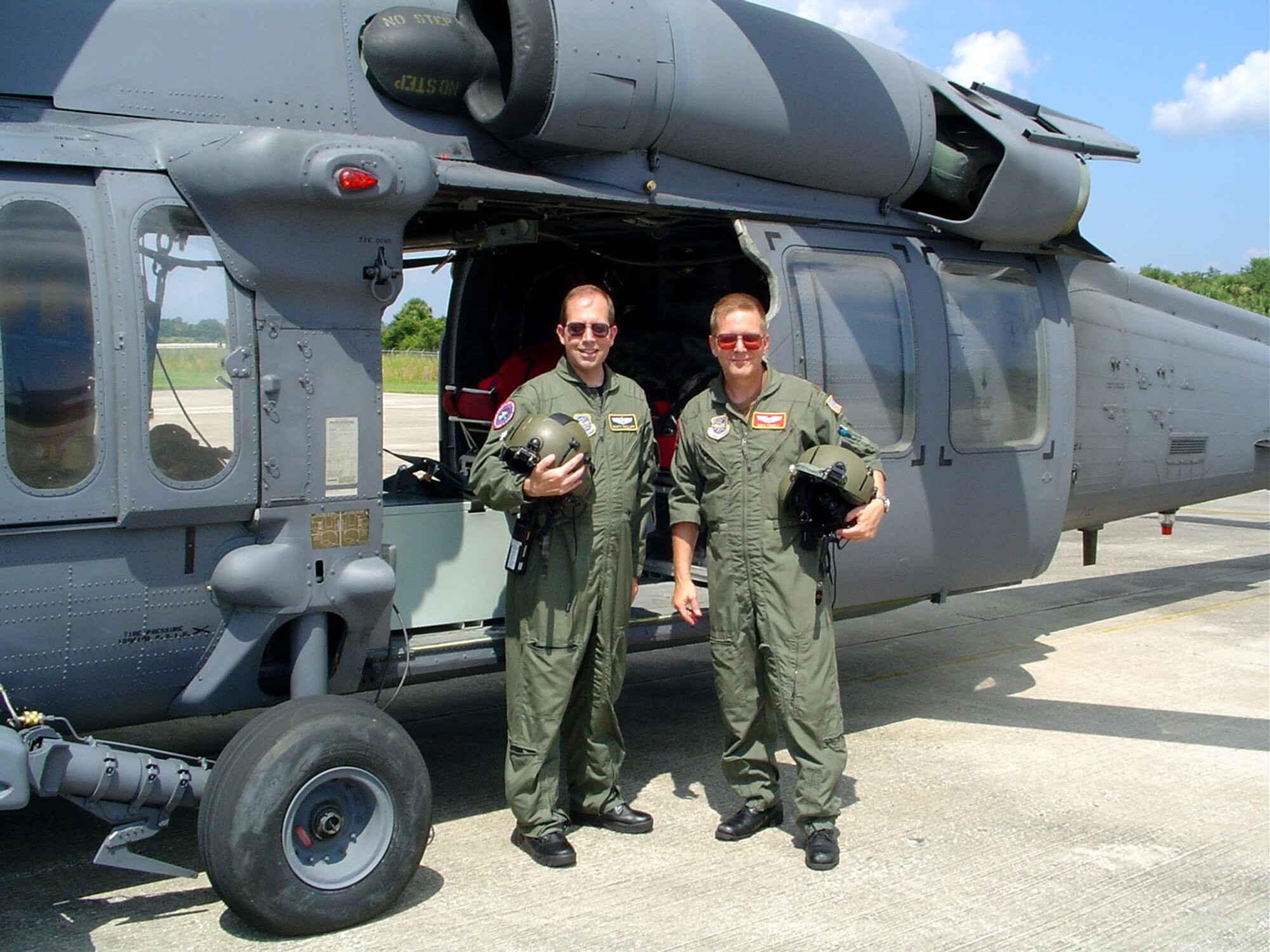Lt. Col. (Dr.) Scott Phillips, left, and Maj. (Dr.) Greg Pinnell stand next to a rescue helicopter near Cape Canaveral Fla. The two doctors with the 434th Aerospace Medicine Squadron moonlight with NASA as part of a shuttle recovery medical team. (U.S. Air Force photo)
