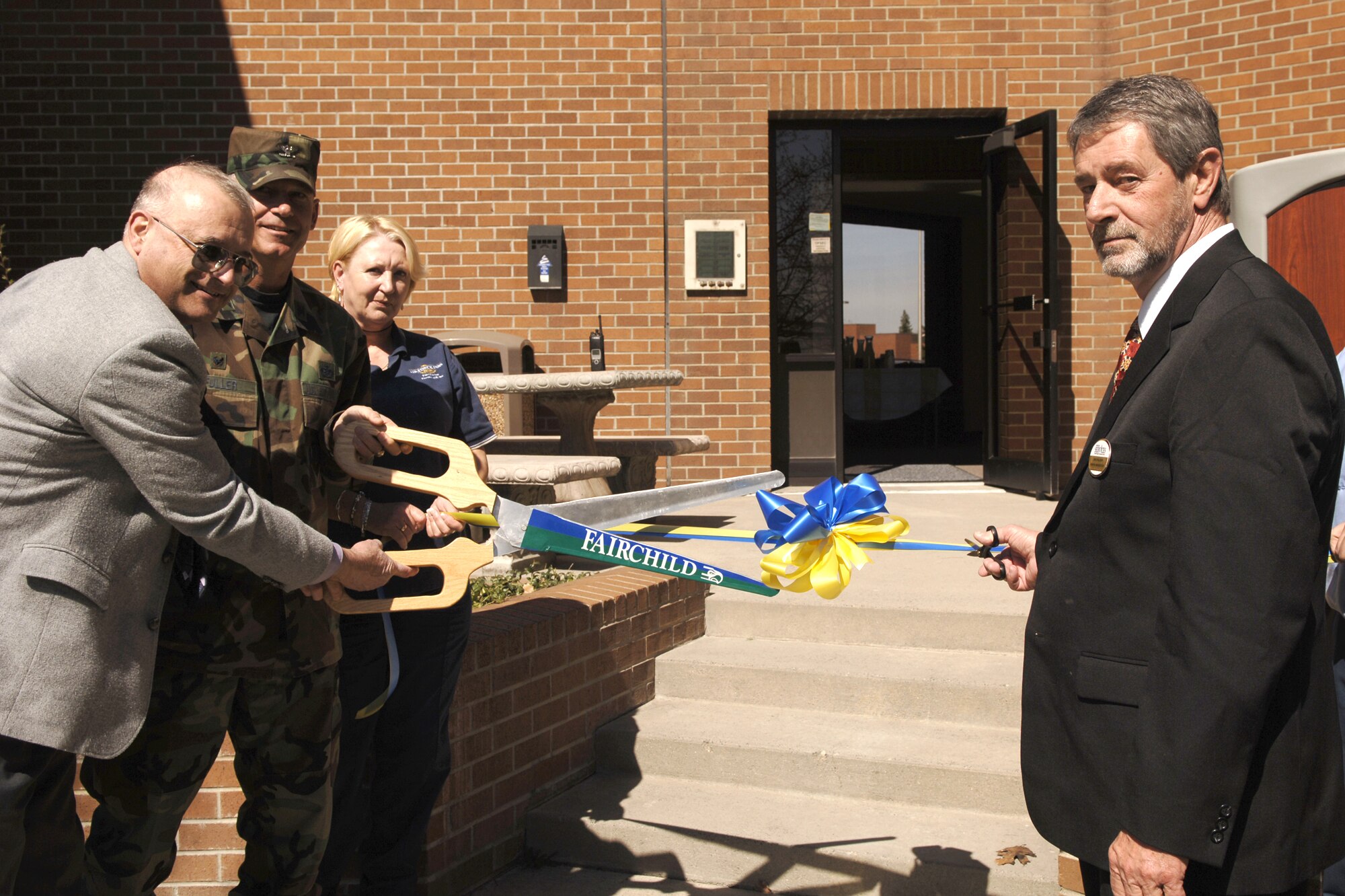 FAIRCHILD AIR FORCE BASE, Wash. -- From left, Joe Shogun; Col. Van Fuller, 92nd Mission Support Group commander; Ann Perry, lodging staff; and David Falconer, lodging manager cut the ribbon at a Fairchild Inns ceremony here April 6. They’re standing in front of newly renovated visitors’ quarters, which now offer 360 square feet of living space for guests. (U.S. Air Force photo/Airman 1st Class Nancy Hooks)