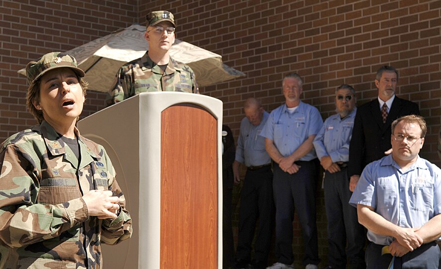 FAIRCHILD AIR FORCE BASE, Wash. -- Maj. Gina Humble, 92nd Services Squadron commander, sings the national anthem at a ribbon cutting ceremony here April 6. The ceremony celebrated the opening of new visitors’ quarters at the Fairchild Inn, a project that has been in the making for the past year. (U.S. Air Force photo/Airman 1st Class Nancy Hooks)