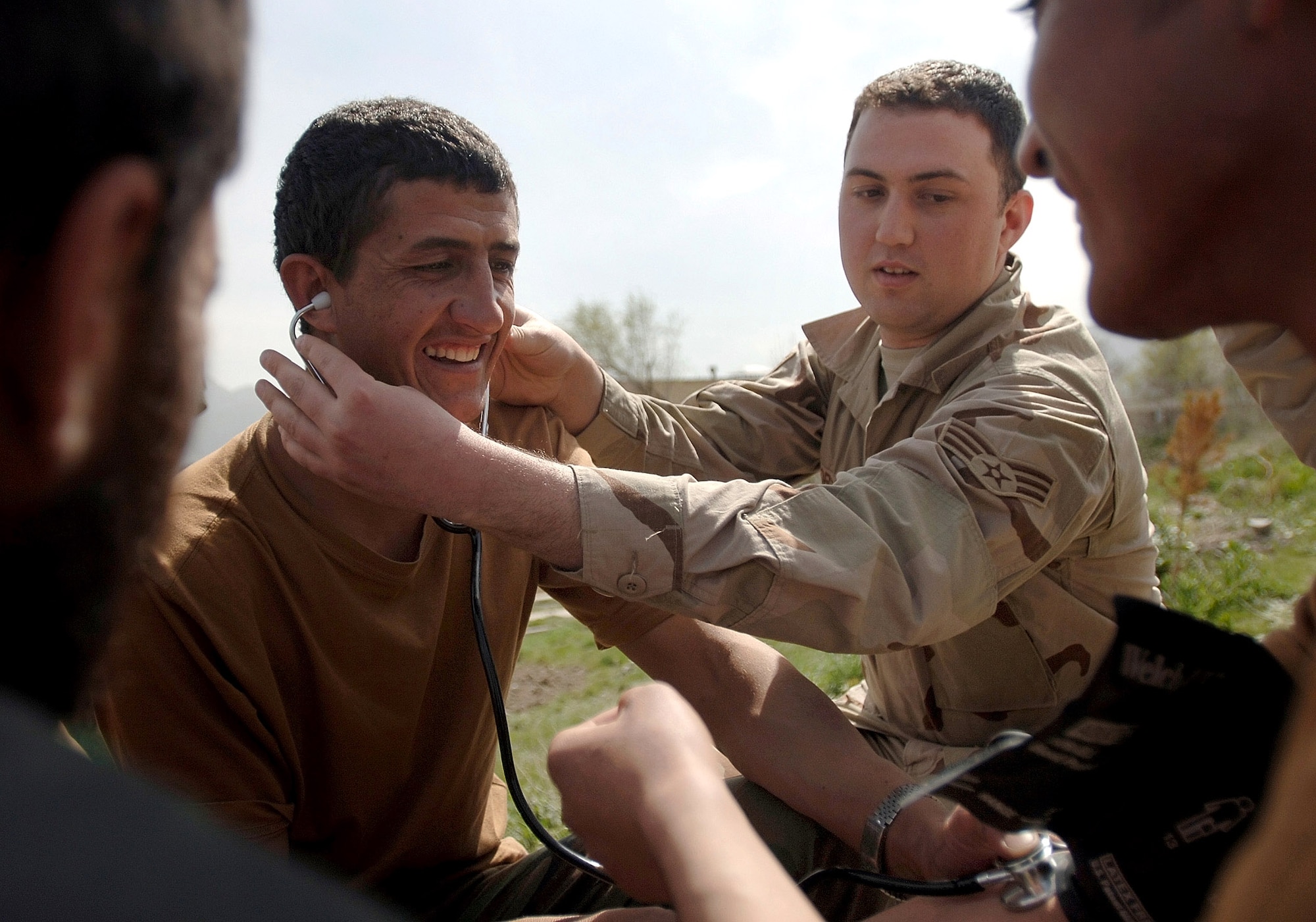 Senior Airman Phillip Borde teaches a hands-on training course with Afghan National Army soldiers on how to take vital signs in the field near Kabul, Afghanistan. The soldiers are participating in the Combat Medic Course. Airman Borde is a mentor assigned to the Combat Medic School. (U.S. Air Force photo/Tech. Sgt. Cecilio M. Ricardo Jr.)