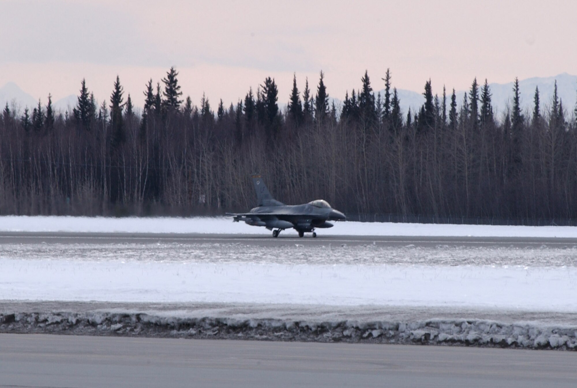 An F-16 Fighting Falcon touches down on the runway for Red Flag-Alaska 07-1 April 3 at Eielson Air Force Base, Alaska. More than 1,300 military members from the United States, France and Australia will train together for two-weeks on the Pacific Alaskan Range Complex during Red Flag-Alaska. Air operations are flown out of Eielson and Elmendorf Air Force bases. This F-16 is from the 61st Fighter Squadron based at Luke AFB, Ariz. (U.S. Air Force photo/Airman 1st Class Jonathan Snyder)
