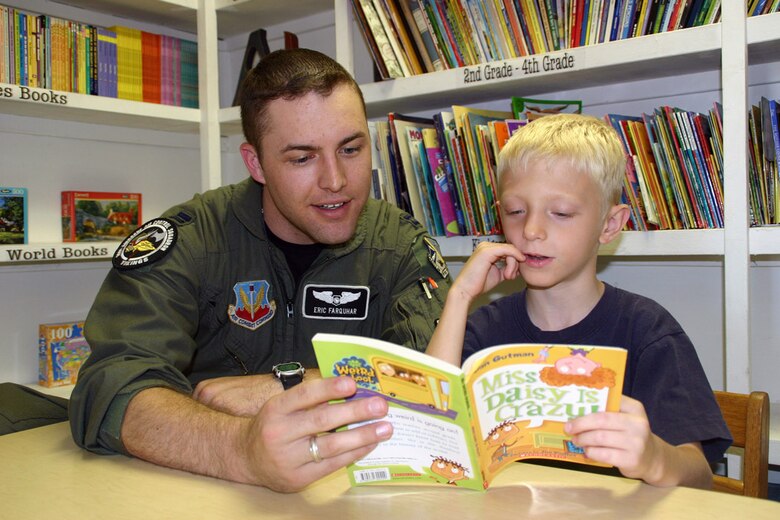 (TINKER AIR FORCE BASE, Okla.) Capt. Eric Farquhar, 960th Airborne Air Control Squadron, reads a story to a child in the Citizens Caring for Children program. In the past year members of the 552nd Air Control Wing have helped out their local communities in big ways. From food to shelter to education, Airmen from the wing have stepped up to the plate and hit a home run that has affected the lives of people all over the Oklahoma City area. (Air Force photo by Senior Airman Lorraine Amaro)