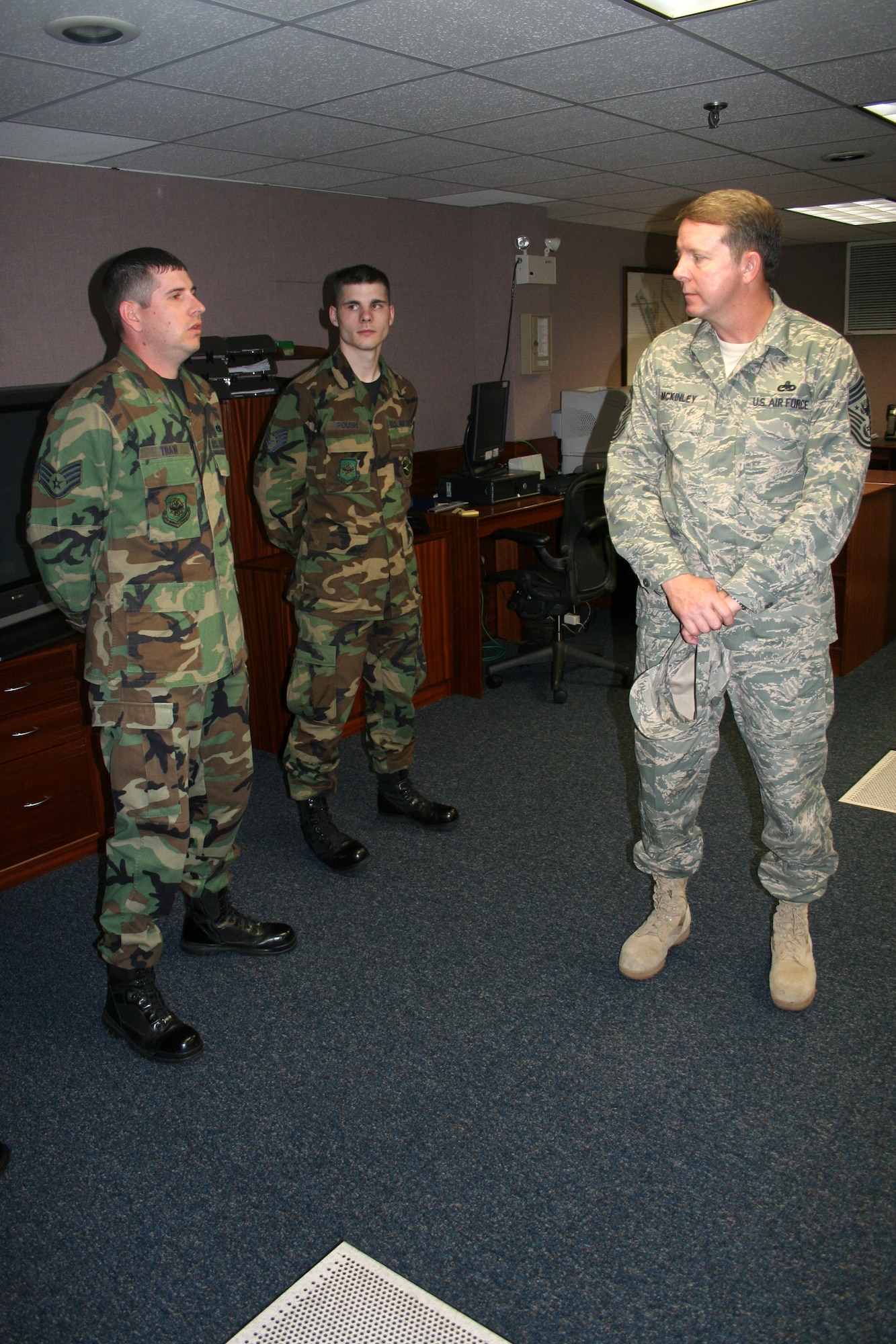 Chief Master Sgt. of the Air Force Rodney J. McKinley speaks with Staff Sergeants Kenneth Traw and Gregory Roush at Lajes Field, Azores. Chief McKinley is touring bases throughout the U.S. Air Forces in Europe promoting several new changes on the way, including uniforms, updated enlisted performance reports, and a warrior ethos. Sergeants Traw and Roush are from the 729th Air Mobility Squadron. (U.S. Air Force photo/Staff Sgt. Marcus McDonald)