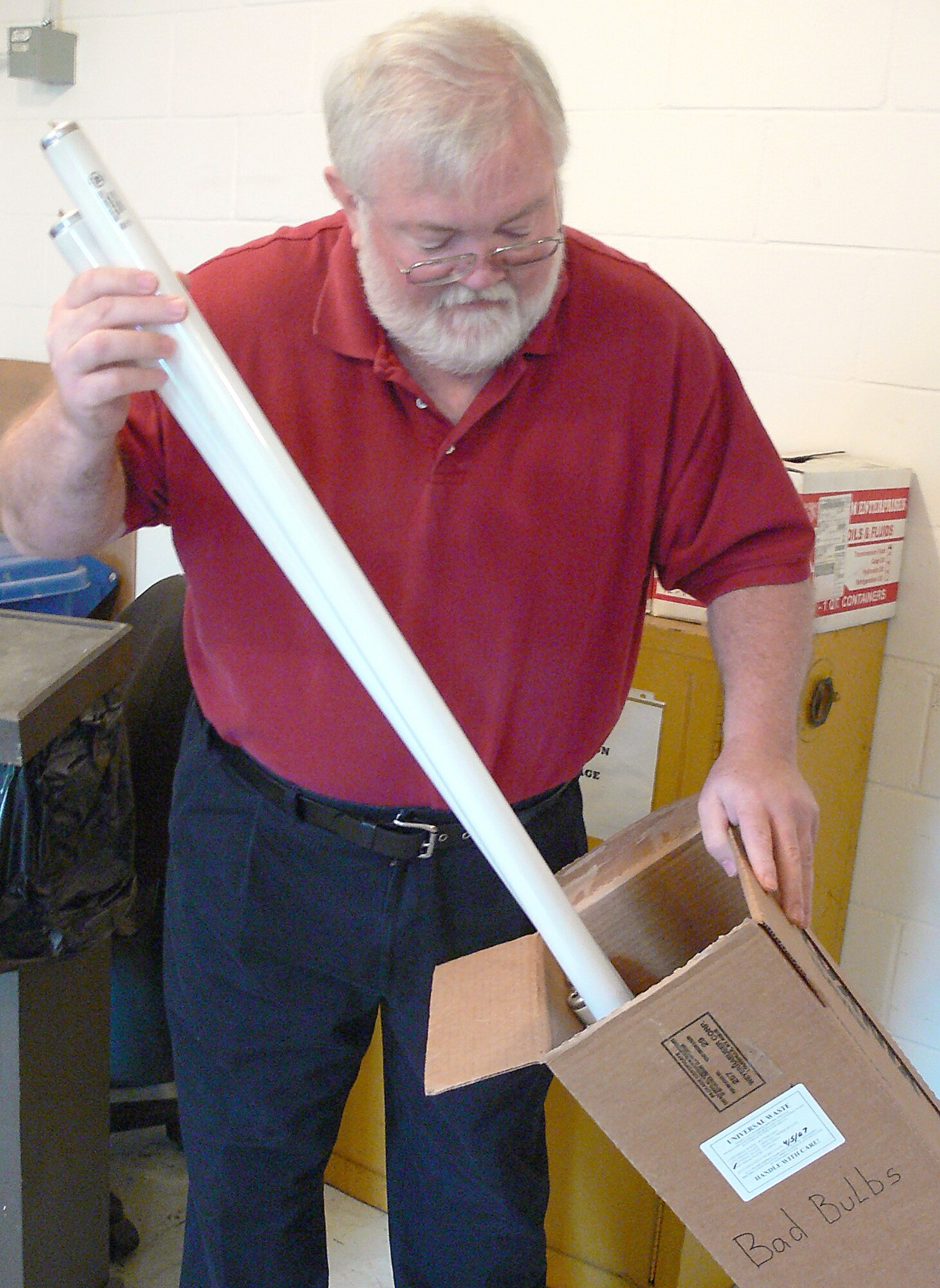 Michael Downey, Hazardous Materials Pharmacy site manager, correctly disposes a mercury-containing flourescent light tube April 9. Moody has received several violations in recent years for improper management of these items, which can be corrected by simple storage techniques. (U.S. Air Force photo by Airman 1st Class Eric Schloeffel)