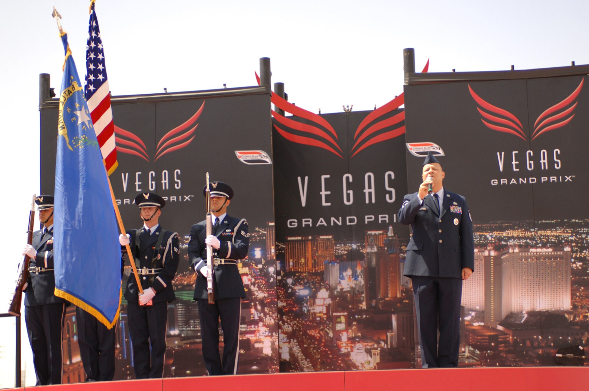 Master Sgt.Robert Brooks Nellis Airman Leadership School flight chief sings the national anthem while members of the Nellis Air Force Base Honor Guard Presents the colors for the inaugural Vegas Grand Prix April 8, 2007.  (U.S. Air Force Photo/Senior Airman Jason Huddleston)