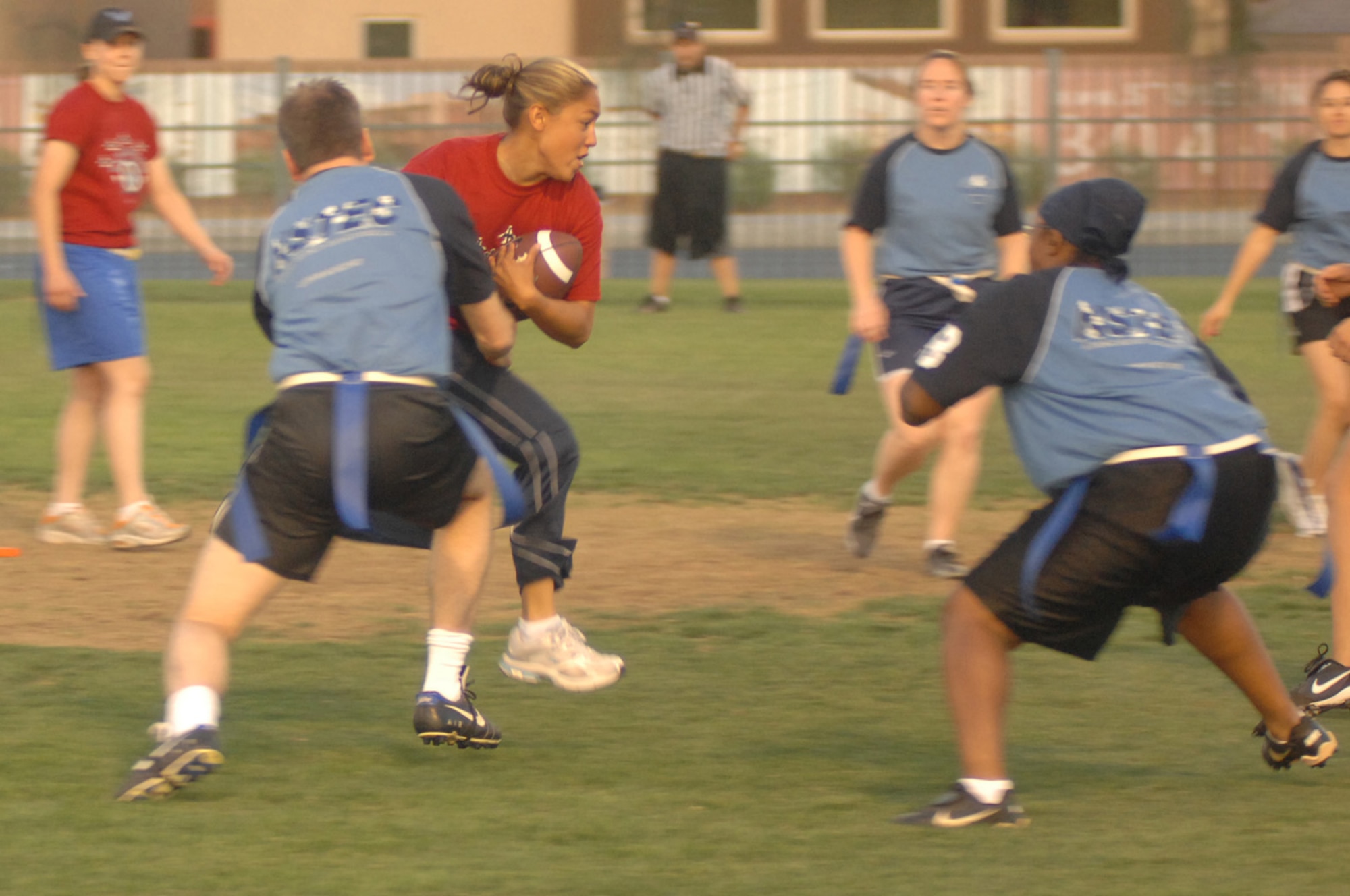Ashlee Huver rushes the ball for positive yards against the National Security Tech Team (NST). Nellis went on to beat NST 26-0 and took 2nd place in the event. (U.S. Air Force Photo/Senior Airman Jason Huddleston)