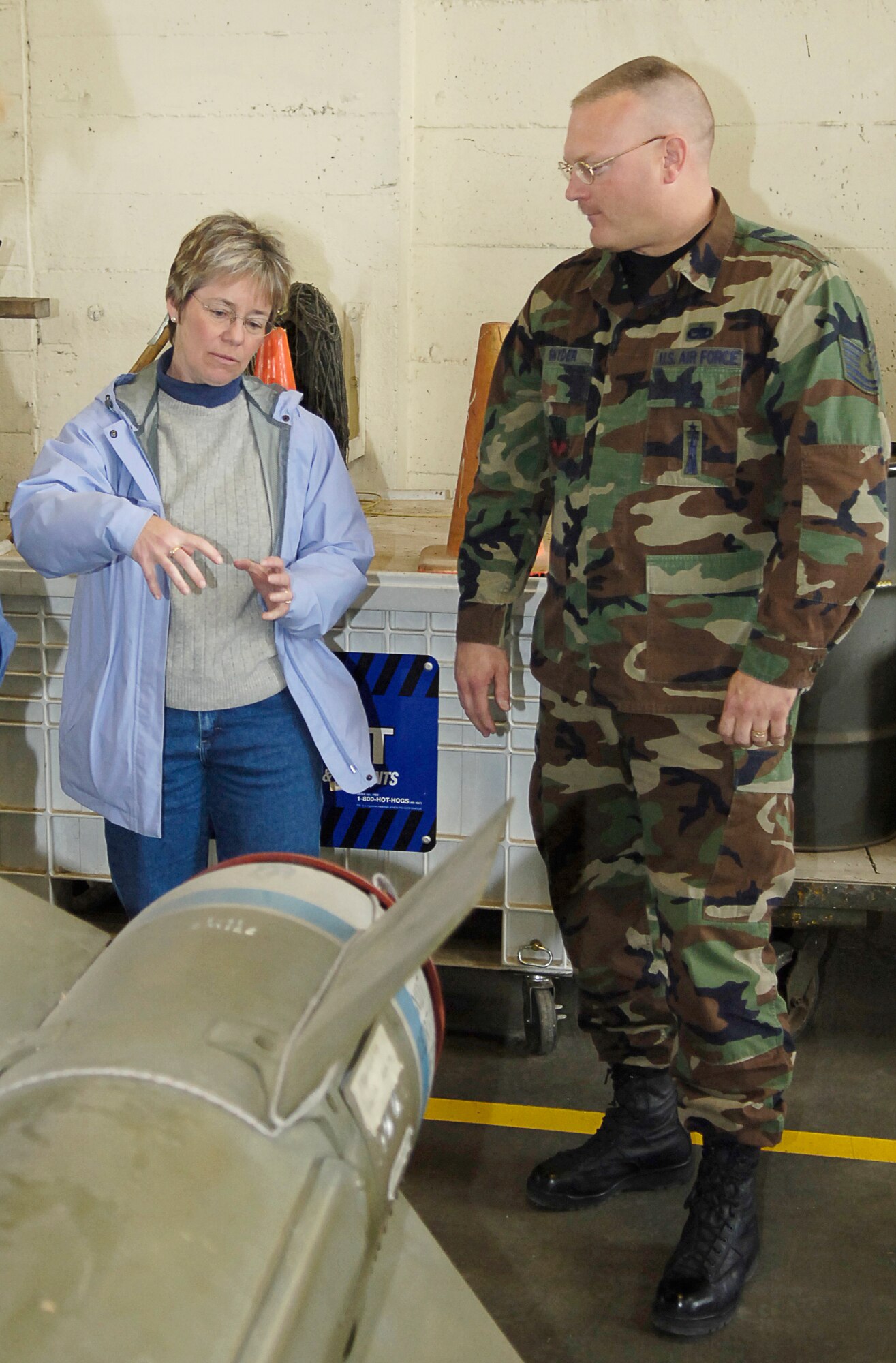 MOUNTAIN HOME AIR FORCE BASE, Idaho – Tech. Sgt. Christopher Snyder, 366th Maintenance Operations Squadron, explains the features of various munitions to Andrea Zollweg during a base visit April 9. Ms. Zollweg was one of 18 members of the Boise Parks and Recreation’s adapted recreation organization that visited Hangar 208, the wing life support shop and the base’s air traffic control tower simulator for a first-hand look at the base’s fighter mission. The 366th Fighter Wing Safety Office works with the parks and recreation department to organize these visits once a year. Air Force photo by Airman 1st Class Ryan Crane