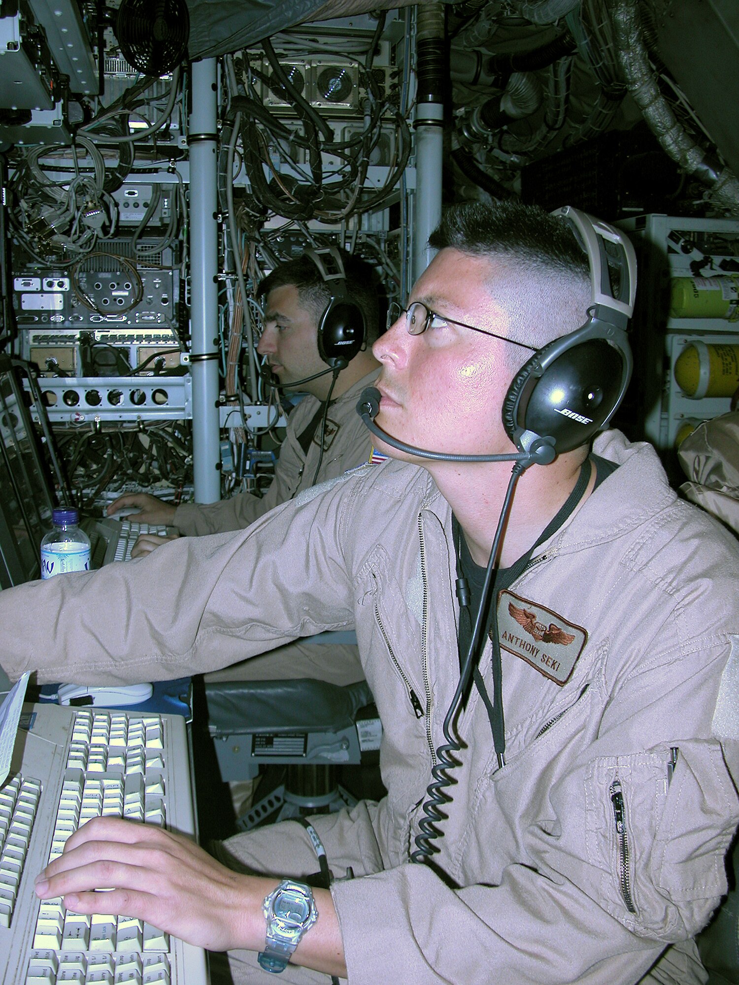 Capt. Anthony Seki, an electronic warfare officer, keeps a watchful eye during a mission April 4 on a RC-135 V/W Rivet Joint. Captain Seki is assigned to the 763rd Expeditionary Reconnaissance Squadron in Southwest Asia. The 763rd ERS mission is to provide real time on-scene intelligence collection, surveillance and analysis to forces in the air and on the ground. (U.S. Air Force photo)