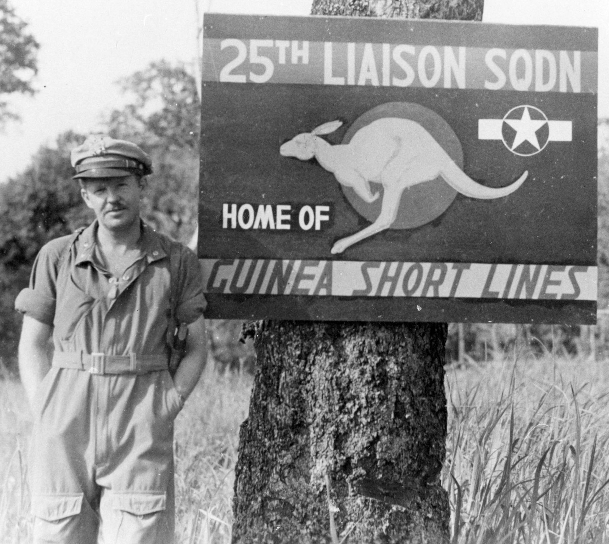 Liaison pilot in New Guinea wearing typical flying clothing for the Southwest Pacific, a light flying suit and a summer 50-mission crush cap. (U.S. Air Force photo)