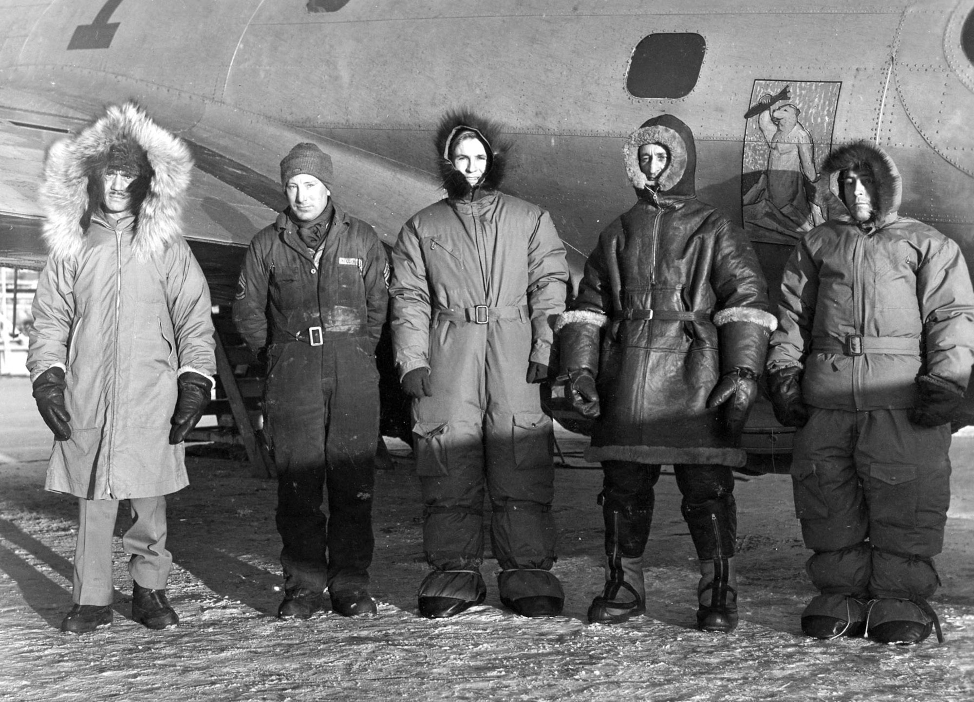 Aircrew testing cold weather flying clothing at Ladd Army Air Field, Alaska, in 1941.  The technical sergeant second from the left is wearing the most common arctic flying uniform early in the war, which in severe conditions would be supplemented with a heavy sheep-shearling jacket and a fur cap. (U.S. Air Force photo)