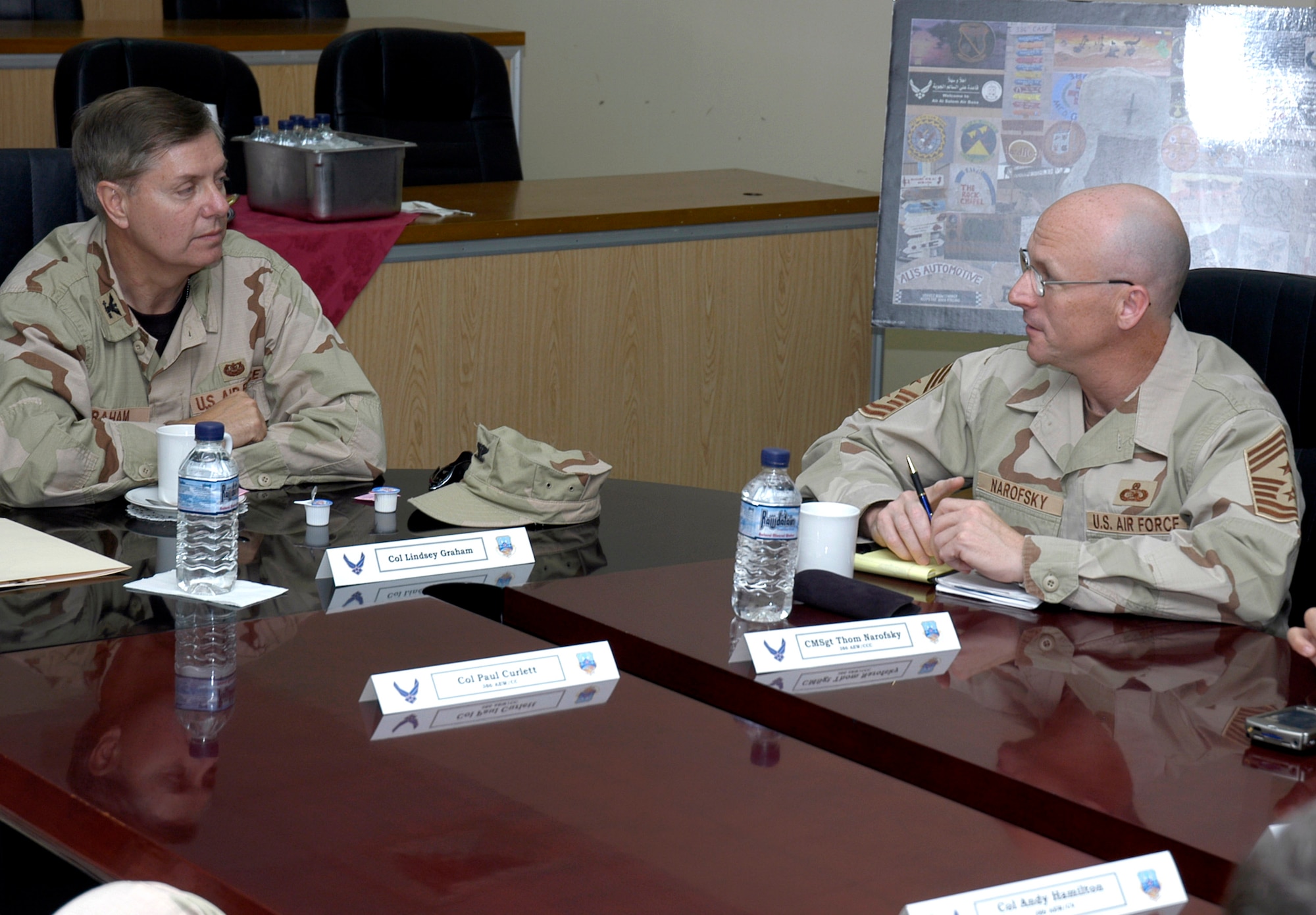Col. Lindsey Graham chats with Chief Master Sgt. Thomas Narofsky during a briefing in the wing conference room April 9 in Southwest Asia. The senior senator from South Carolina is a Reserve judge advocate. He recently spent two days in Iraq with Sen. John McCain, then another week as a JA with the Multinational Force, Iraq. Chief Narofsky is the 386th Air Expeditionary Wing command chief. (U.S. Air Force photo/Staff Sgt. Ian Carrier)
