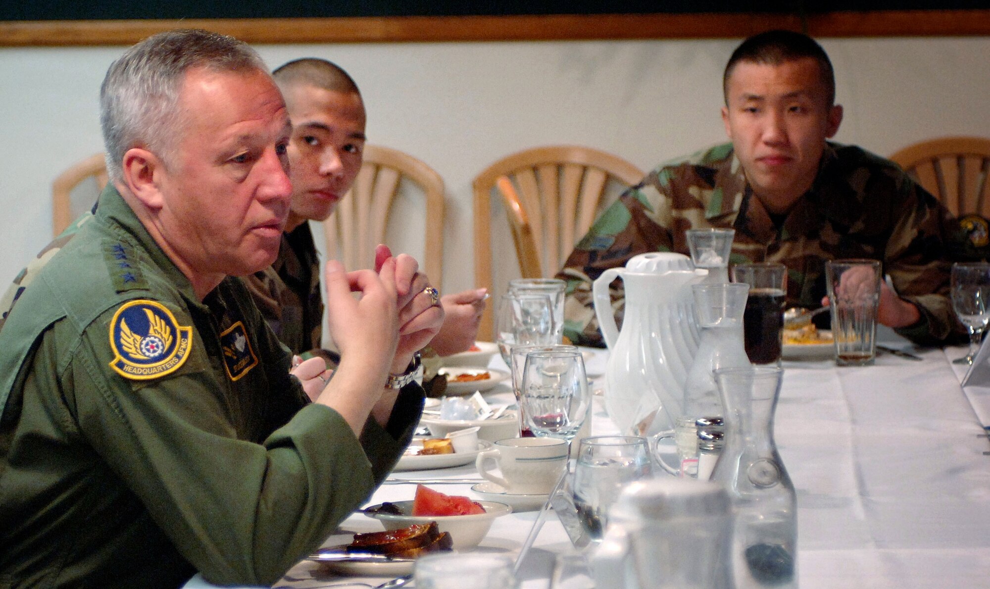 General  Bruce Carlson, AFMC/CC, eats breakfast with Airman First Class Sung Kim and Airman Jed Dauz and 18 other Airman at Hill Air Force Base's Hillcrest Dining Facility.  During the meal, General Carlson and this year's 75th Air Base Wing Airman of the year recipients discussed the topics of the Global War on Terrorism, Force Shaping and the importance of personal financial responsibility.   (Air Force photo by Efrain Gonzalez) 