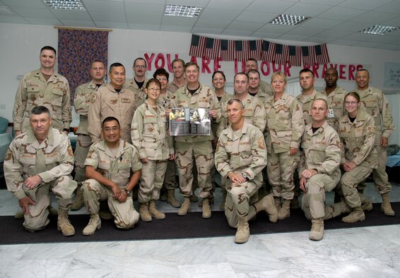 SOUTHWEST ASIA -- Col. Lindsey Graham, a Senior Senator from North Carolina, poses with members of the 386th Expeditionary Medical Group in the Contingency Air Medical Staging Facility here on the Rock on April 9, 2007. Col. Graham, a Reserve Judge Advocate, recently spent 2 days in Iraq with Senator John McCain, then another 7 days as a JA with the Multinational Force, Iraq. Col. Graham is holding a copy of the Desert Voice open to an article that was written on the CASF.(AF photo/Staff Sgt. Ian Carrier)                                                               