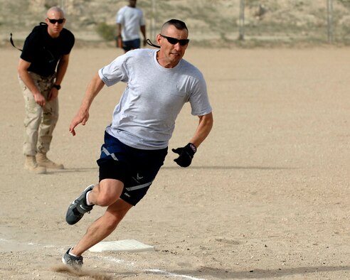 SOUTHWEST ASIA -- Maj. Steven King, 386th Expeditionary Contracting Squadron, rounds third base and heads for home during the 386th Air Expeditionary Wing softball championship game April 8, 2007. The Wing Staff team defeated Security Forces by a score of 13-10. (AF photo/ Tech. Sgt. Edward Holzapfel)