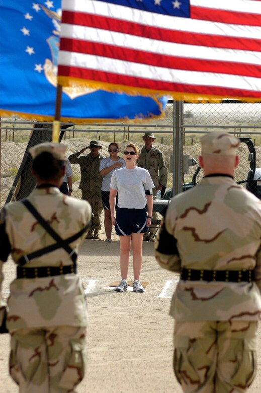 SOUTHWEST ASIA -- Staff Sgt. Katherine Holton, 386th Expeditionary Security Forces Squadron, sings the National Anthem during opening ceremonies for the 386 AEW softball championship April 8, 2007. The Wing Staff defeated Security Forces 13-10. (AF photo/ Staff Sgt. Ian Carrier)                              