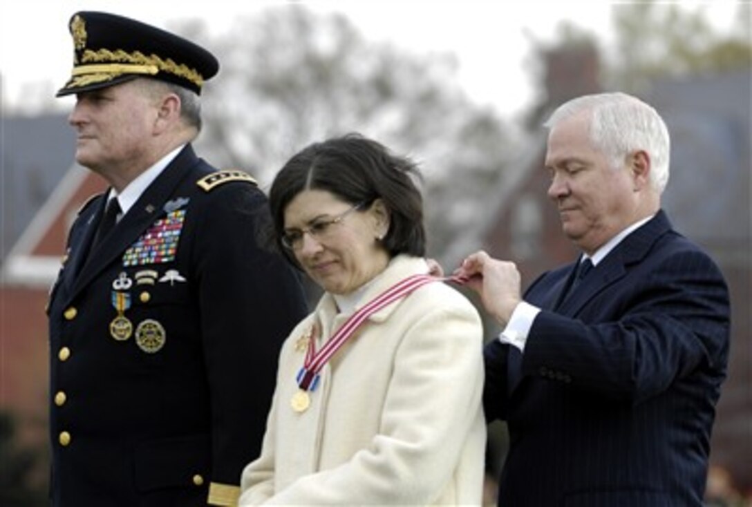 Defense Secretary Robert M. Gates presents a medal to Cindy Schoomaker, wife of outgoing Army Chief of Staff Gen. Pete Schoomaker, during the U.S. Army Chief of Staff change of responsibility ceremony at Fort Myer, Va., April 10, 2007. 
