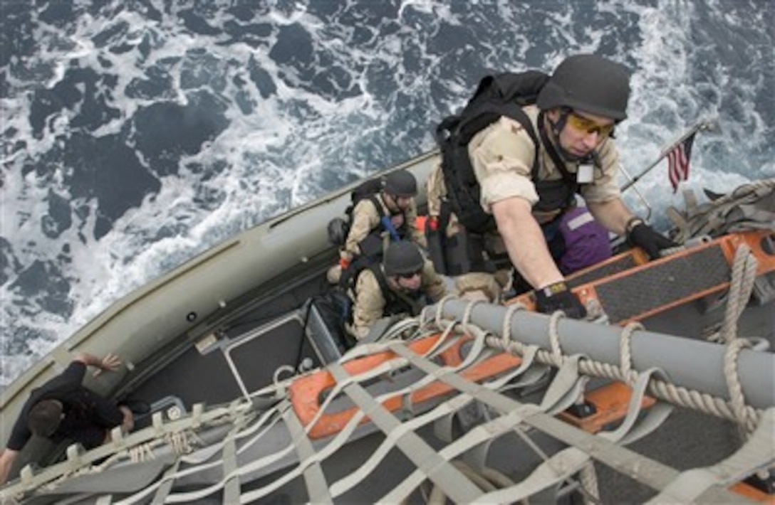 U.S. Navy Petty Officer 3rd Class James Cauble climbs aboard the USS Mustin (DDG 89) after returning from the Indian navy ship INS Ranjit (DDG) for a drill in the Philippine Sea on April 7, 2007.  Cauble, and his visit, board, search and seizure team members from the Mustin, conducted a boarding drill as part of exercise Malabar 07-01, a U.S. and Indian naval exercise held off the coast of Okinawa, Japan.  