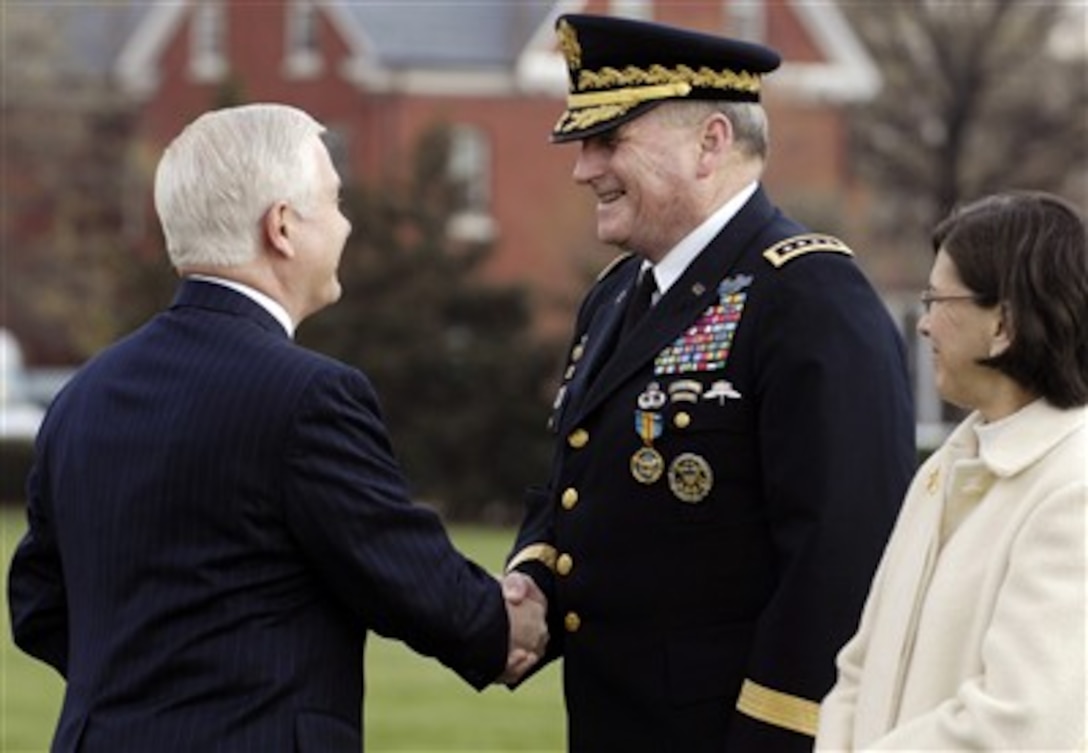 Secretary of Defense Robert M. Gates shakes hands with Gen. Peter J. Schoomaker after presenting him with the Defense Distinguished Service medal while his wife Cindy Schoomaker watches during the U.S. Army Chief of Staff change of responsibility ceremony at Fort Myer, Va., on April 10, 2007.  Schoomaker was succeeded by Gen. George W. Casey who became the 36th Chief of Staff of the Army.  