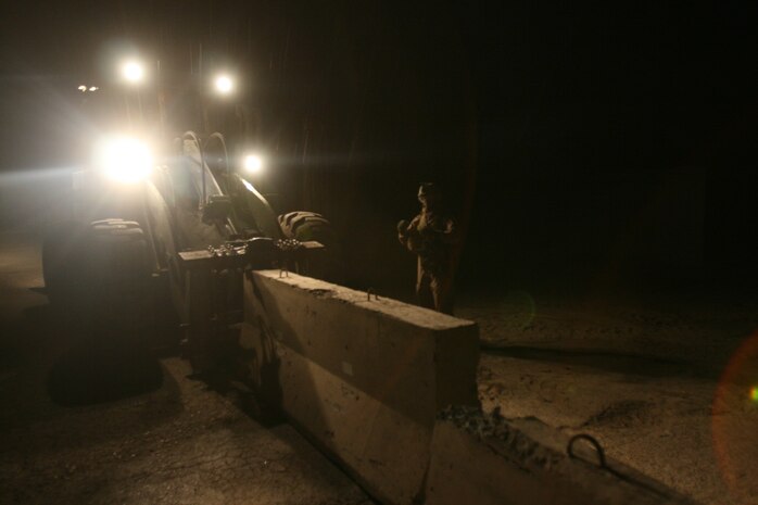 SAQWALIYAH, Iraq (April 10, 2007) ? Marines with Transportation Support Company, Combat Logistics Battalion 6, 2nd Marine Logistics Group (Forward), transported and emplaced barriers as a force protection measure at a nearby infantry outpost, April 10.  The Marines emplaced 44 new barriers and moved 10 pre-existing barriers through the wind, rain and darkness.