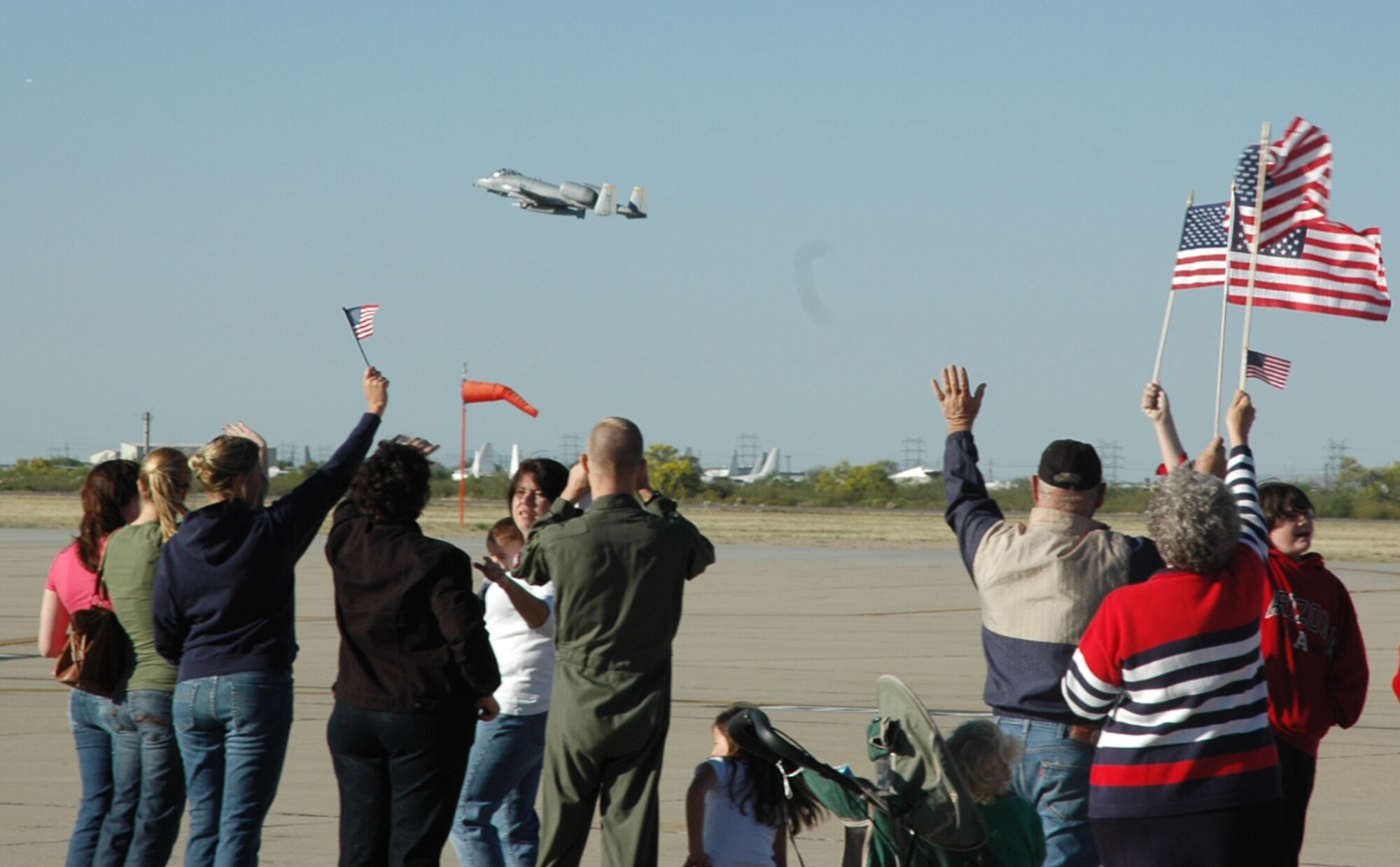 An A-10 Thunderbolt II from the 354th Fighter Squadron takes off from D-M, as friends, family members and colleagues bid farewell. Twelve A-10 pilots from the 354th FS deployed to Afghanistan April 7 to support Operation Enduring Freedom. (U.S. Air Force photo/Airman 1st Class Melissa Taeu)