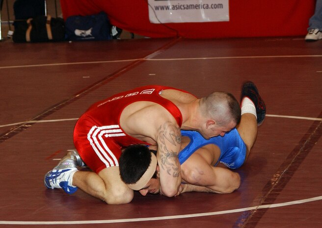 Air Force Staff Sgt. Jacob Hey (red) USAF Wrestling matches up against Marco Lara (blue) in a Greco-Roman style match at the Las Vegas Convintion Center April 7, 2007.  In Greco-Roman wrestling, a team of three referees is used. The referee controls the action in the center, blowing the whistle to start and stop the action. The judge sits at the side of the mat. The mat chairman sits at the scoring table and keeps time. To award points, assess penalties, or call a pin, two of the three officials must agree. (U.S. Air Force photo by Staff Sgt. Jeremy Smith)   