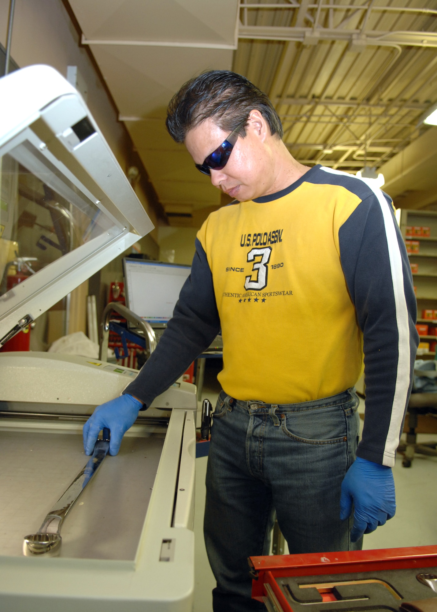 Mr. Allan Bartolome, 49th Logistics Readiness Squadron, uses a laser etcher used for tool accountability.  (U.S. Air Force photo by Airman 1st Class Jamal Sutter)