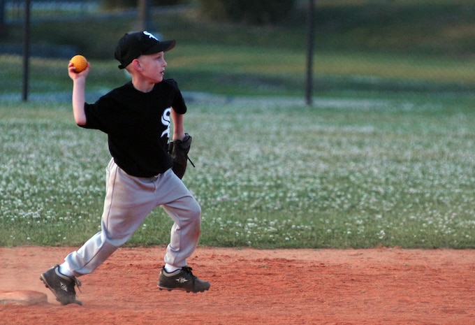 Vincent Tascione, 7, son of Tech Sgt. Pete and Cindy Tascione, throws the ball to first base during his team's game against the Cubs April 6.(U.S. Air Force photo/Airman Melissa Harper)
