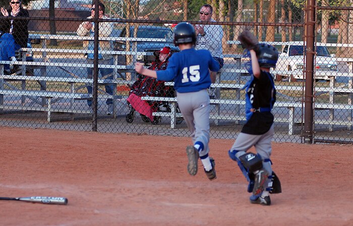 Parker Hula, 9, son of Lt. Col. Russell and Liz Hula, scores a run for the Cubs in their game against the White Sox April 6. (U.S. Air Force photo/Airman Melissa Harper)