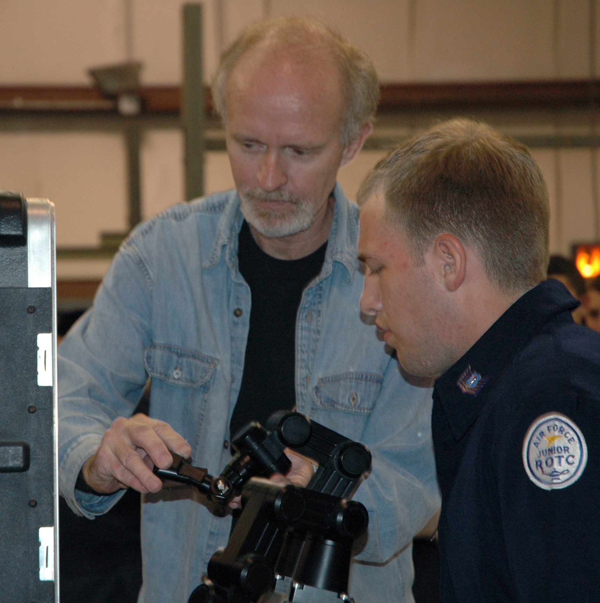 Steve Blackman, Air Force Research Laboratory robotics technician, demonstrates how to move the robotic arm of an All Purpose Remote Transport System to Thadus Patterson, Rutherford High School Air Force Junior Reserve Officer Training Corps cadet.  Students from local schools have been invited to attend Robotics Week at AFRL April 30 - May 4. (U.S. Air Force Photo by Chrissy Cuttita)