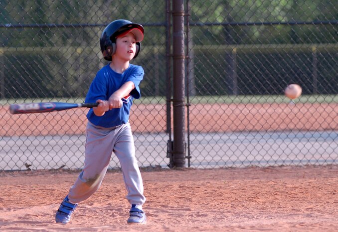 Dante Conzonere, 8, son of Tech. Sgt. Anthony and Mary Conzonere, swings at the ball for the Cubs in their game against the White Sox April 6. (U.S. Air Force photo/Airman Melissa Harper)