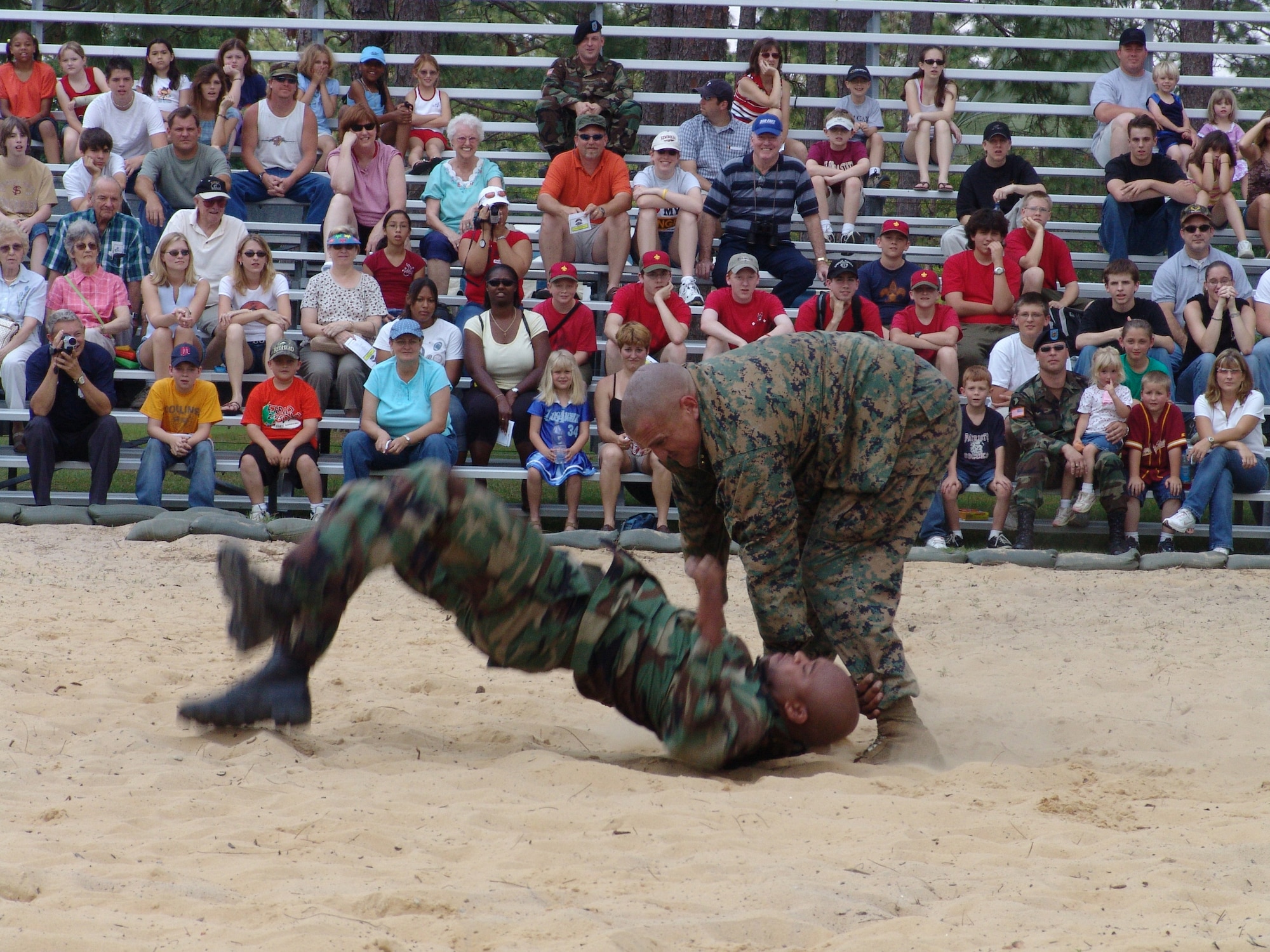 CAMP RUDDER, Fla. -- U.S. Marine Corps Gunnery Sgt. Craig Chilson demonstrates how to take an opponent down on U.S. Army Staff Sgt. Labaron Paschall during the hand-to-hand combat demonstration at a previous 6th Ranger Training Battalion Open House. The 6th RTB, stationed at Auxiliary Field 6 on the Eglin Air Force Base military reservation, will be hosting a 5k and 10k race prior to the Ranger Camp's annual Open House event May 6. Demonstrations will include rappelling, weapons, parachute as well as boat and reptile displays. (U.S. Air Force photo by Staff Sgt. Mike Meares)             