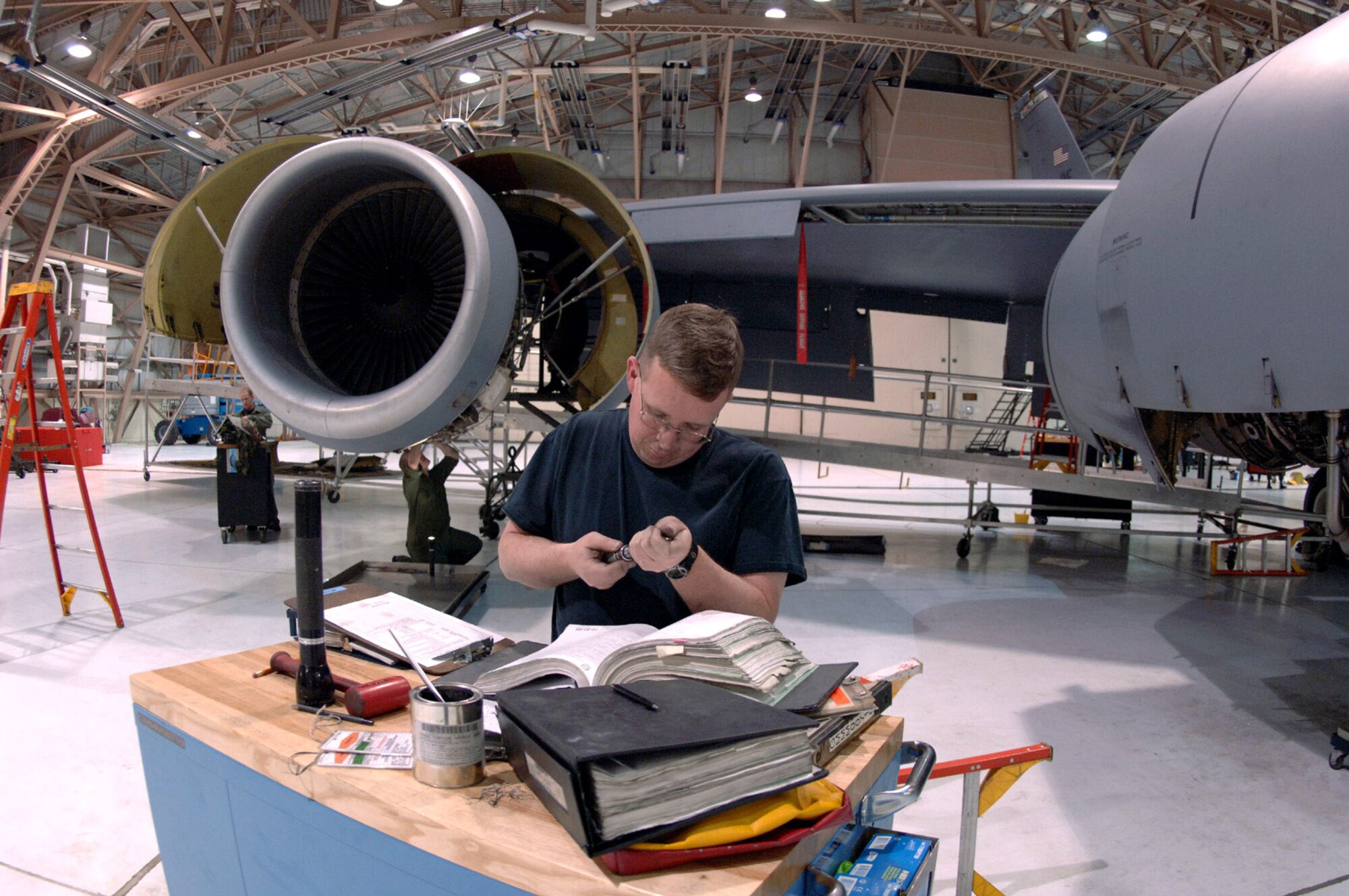 Staff Sgt. Brian O'Day cross-references a part with reference material during a periodic inspection at Grand Forks Air Force Base, N.D. Every KC-135 Stratotanker goes through periodic inspections every 15 months or 1,500 flight hours. Sergeant O'Day and more than 50 other Airmen assigned to the 319th Maintenance Squadron inspect and repair nearly every system within five to eight days. (U.S. Air Force photo/Airman 1st Class Chad Kellum) 