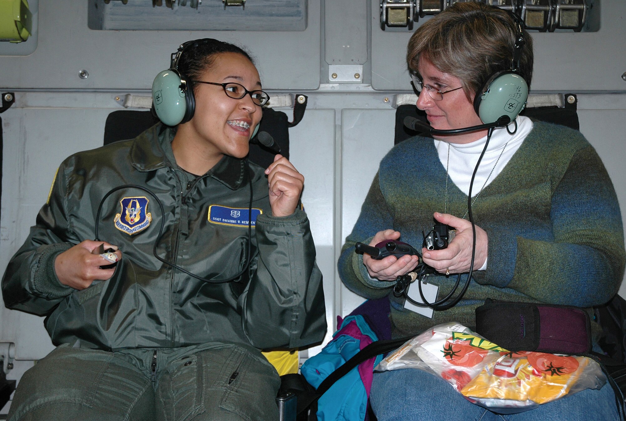 McCHORD AIR FORCE BASE, Wash. - Staff Sgt. Brianne Rembert, left, talks through a headset with Mary Dearth during the 446th Airlift Wing's Employer Orientation Day flight March 31.  Ms. Dearth is Sergeant Rembert's civilian manager at the Multicare Medical Center in Tacoma. Sergeant Rembert is a Reservist with the 446th Aeromedical Staging Squadron. U.S. Air Force photo/Senior Airman Desiree Kiliz