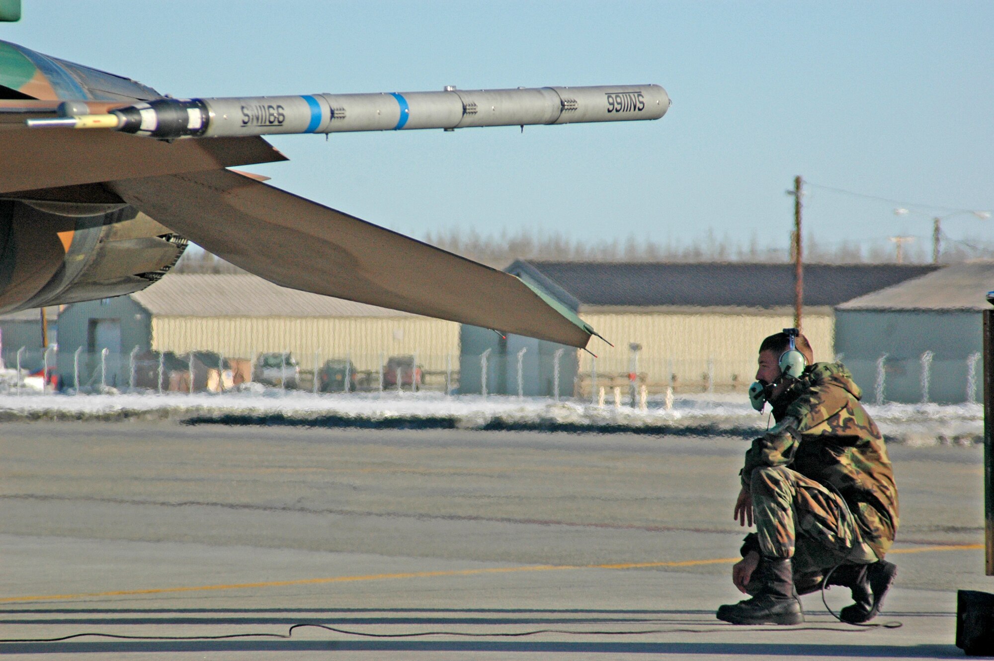 Senior Airman Brian Brammer completes last-minute checks on an F-16 Fighting Falcon prior to a Red Flag-Alaska 07-1 orientation flight April 6 at Eielson Air Force Base, Alaska.  Red Flag-Alaska enables aircrews to sharpen their combat skills by flying 10 simulated combat sorties in a realistic threat environment.  Airman Brammer is a crew chief with the 57th Aircraft Maintenance Squadron.  (U.S. Air Force photo/Senior Airman Justin Weaver)