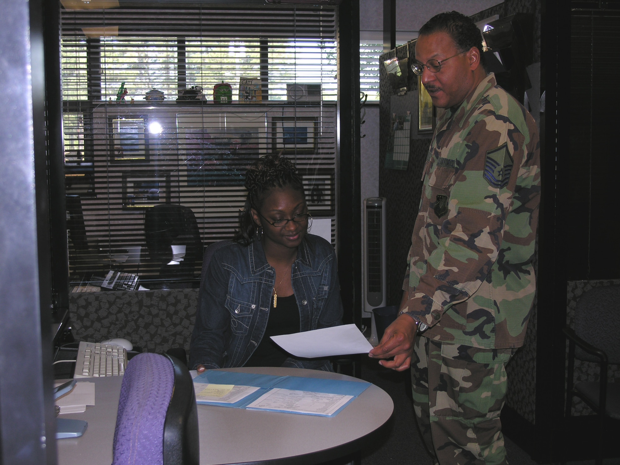 Master Sgt. Martin Cooper of the 916th Air Refueling Wing Mission Support Flight talks with Ms. Amazing Griffin, a new student hire at the North Carolina Reserve wing. Many military installations provide part-time job opportunities to students in areas ranging from administrative support to public affairs to operations. (U.S. Air Force Photo/Ms. Donna Lea)          
