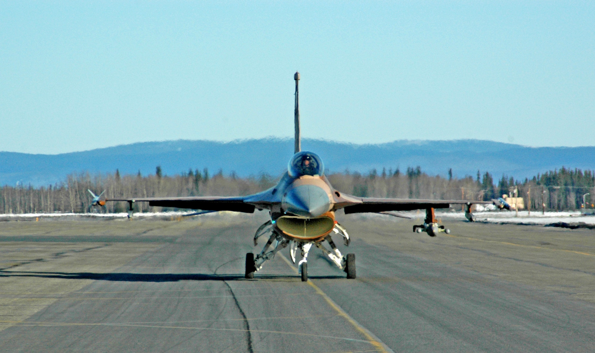 An F-16 Fighting Falcon from the 64th Aggressor Squadron at Nellis Air Force Base, Nev., taxis down the runway at Eielson AFB, Alaska, April 6 for a Red Flag-Alaska 07-1 orientation flight. The exercise, formerly known as Cope Thunder, provides joint offensive counter-air, interdiction, close-air support and large-force employment training in a simulated combat environment. Red Flag-Alaska runs through April 20. (U.S. Air Force photo/Senior Airman Justin Weaver).