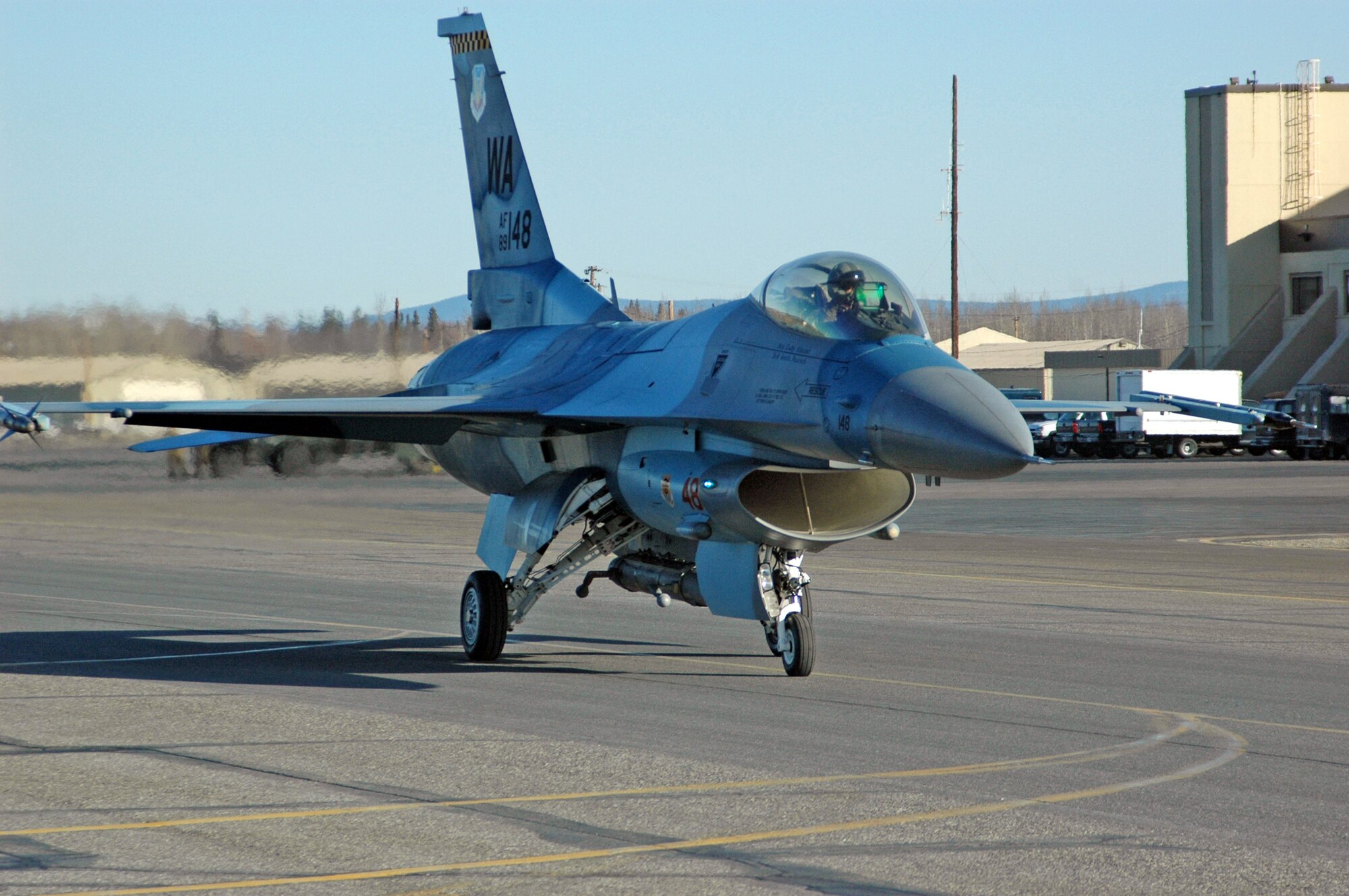 An F-16 Fighting Falcon from the 64th Aggressor Squadron at Nellis Air Force Base, Nev., taxis down the runway April 6 at Eielson Air Force Base, Alaska, for a Red Flag-Alaska 07-1 orientation flight.  Red Flag-Alaska enables aircrews to sharpen their combat skills by flying 10 simulated combat sorties in a realistic threat environment.  Additionally, the training allows them to exchange tactics, techniques, and procedures and improve interoperability. (U.S. Air Force photo/Senior Airman Justin Weaver).