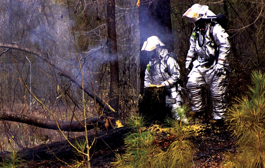 Base firefighters respond to the scene of a fire March 21 in the family campground area here. Three individuals were detained at the scene and charged with arson after Tom Wade, base fire chief, caught them in the act. (U.S. Air Force photo by Airman 1st Class Ciara Wymbs) 
