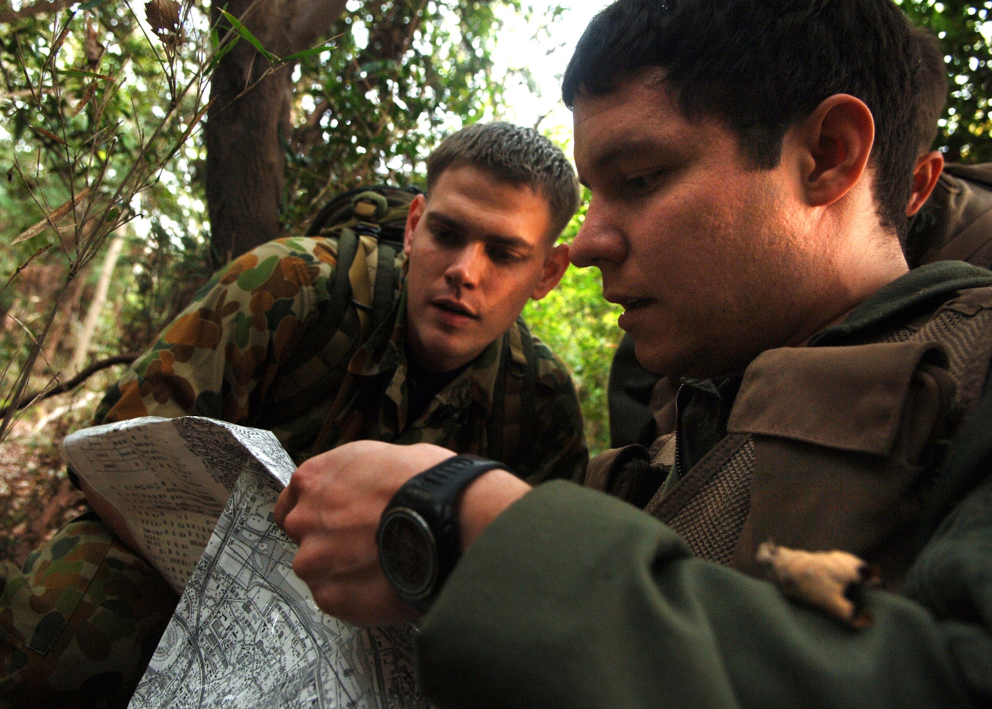 Senior Airman Jason Davis trains Capt. Pierre Alvarado mapping and Global Positioning System skills April 10 at the Tama Hills Recreation Center near Yokota Air Base, Japan. Airman Davis is a a survival, evasion, resistance and escape specialist from the 374th Operational Support Squadron, and was recognized as the 2006 Pacific Air Forces SERE Airman of the Year. SERE specialists train members from all branches of the military on how to survive in all environments and conditions. Captain Alvarado is from the 36th Airlift Squadron. (U.S. Air Force photo/Senior Airman Veronica Pierce) 
