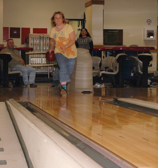 OSAN AIR BASE, Republic of Korea --  Michelle Buffington throws a strike at the MiG Alleys Bowling Center here Tuesday. The bowling center offers open bowl specials all week, with Red Head Pin Bowling from 11 a.m. to 5 p.m. Tuesdays. (U.S. Air Force photo by Staff Sgt. Benjamin Rojek)