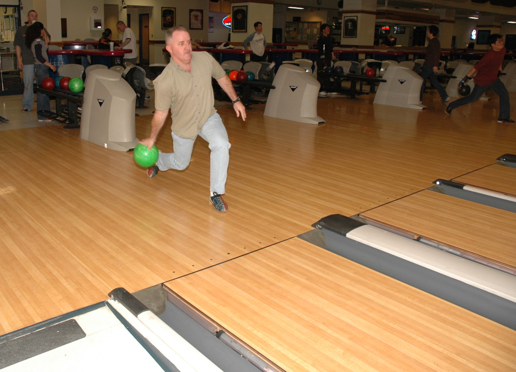 OSAN AIR BASE, Republic of Korea --  Chief Warrant Officer Travis Buffington goes for the spare at MiG Alleys Bowling Center on Tuesday. The bowling center has Red Head Pin Bowling from 11 a.m. to 5 p.m. Tuesdays. If a bowler gets a strike when a red pin is in the number one position, her or she wins a free game. (U.S. Air Force photo by Staff Sgt. Benjamin Rojek)  