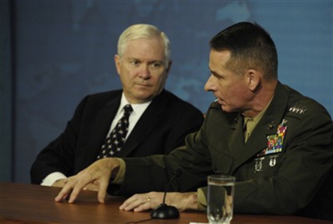 Chairman of the Joint Chiefs of Staff U.S. Marine Gen. Peter Pace fields a reporter's question while Defense Secretary Robert M. Gates looks on during a press conference at the Pentagon, April 11, 2007.  