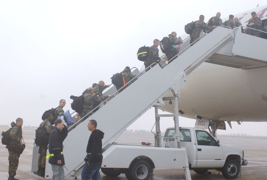 KUNSAN AIR BASE, Republic of Korea  April 13, 2007 -- Airmen deployed from Holloman Air Force Base, N.M., climb aboard a DC-10 bound for home here. The more than 200 Airmen deployment from the F-117 stealth fighter base culminates their four-month air expeditionary force deployment in the Republic of Korea. (U.S. Air Force photo/Senior Airman Darnell Cannady)  