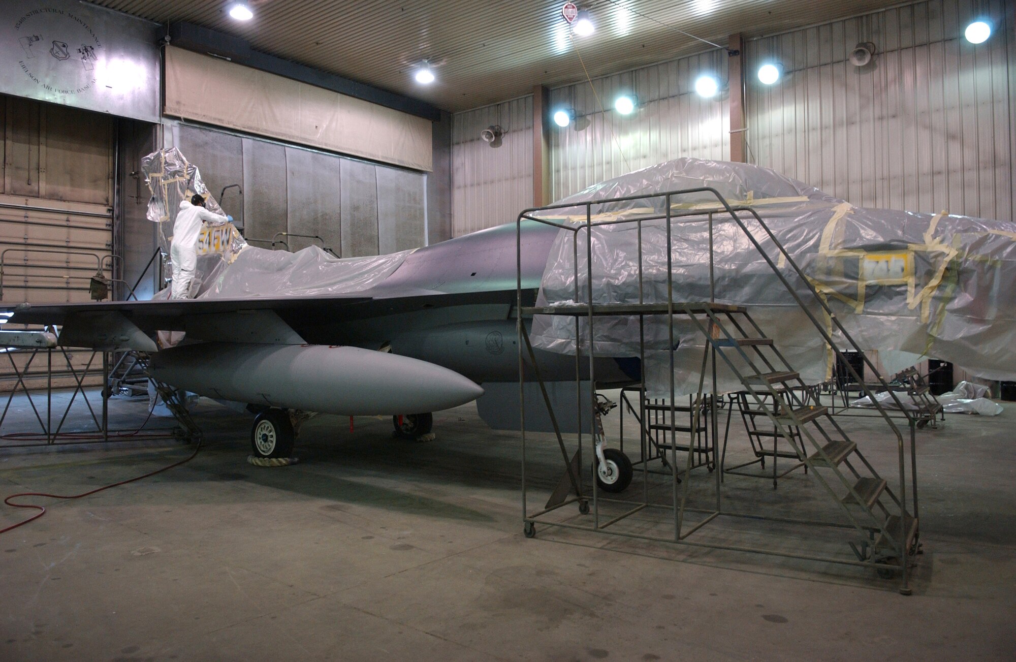 EIELSON AIR FORCE BASE, Alaska -- 'ICEMAN One', the 354th Wing Commanders' F-16 Fighting Falcon, receives a new tail design and a paint touch up here April 12.  The paint job will help prevent future corrosion.  (U.S. Air Force Photo by Airman 1st Class Jonathan Snyder)

